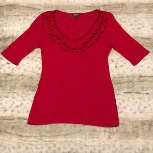 Red top with ruffles around neckline.